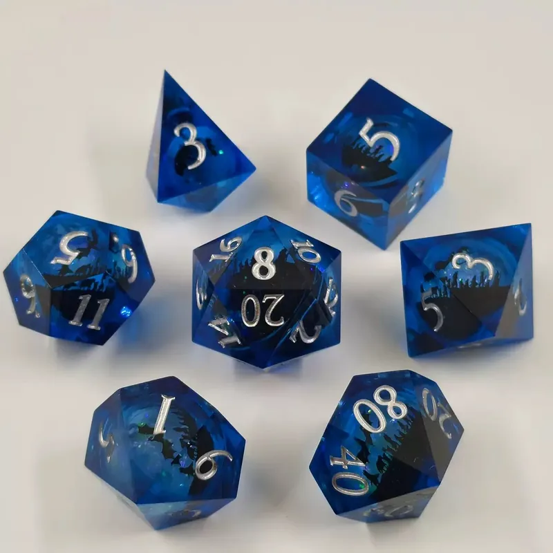 Blue Dragon Resin Dice — Deep-blue sharp-edge resin with a dragon-and-mountain silhouette, silver ink.