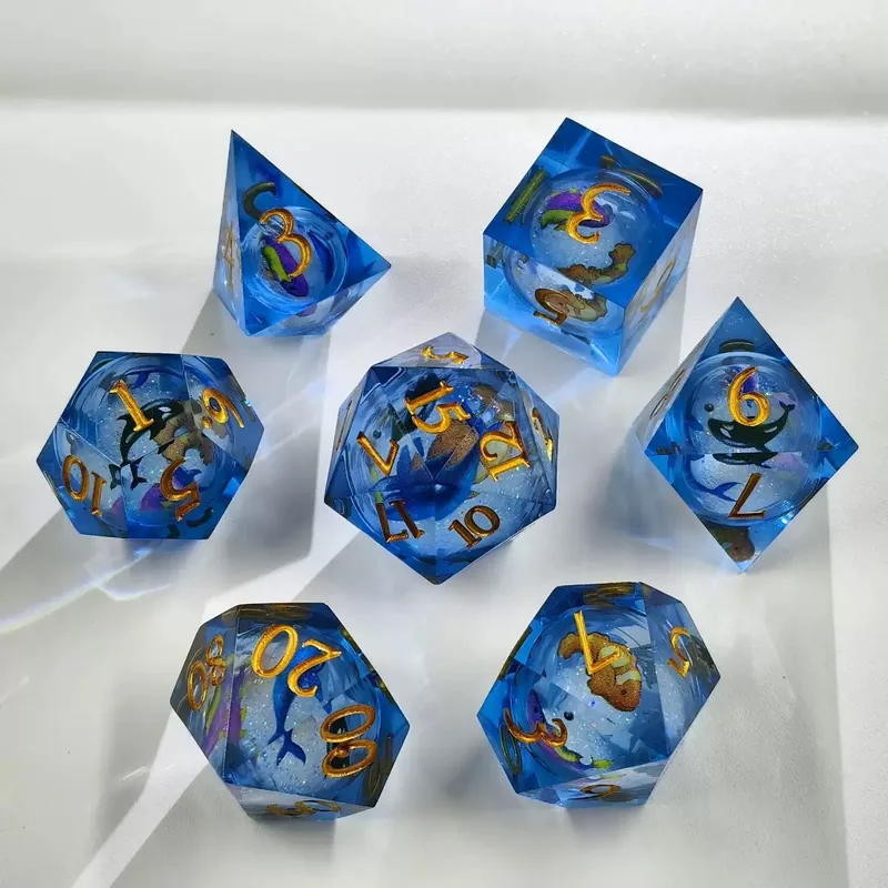 Ocean Blue Resin Dice — Blue sharp-edge resin with sea-creature inclusions and glitter, gold ink.